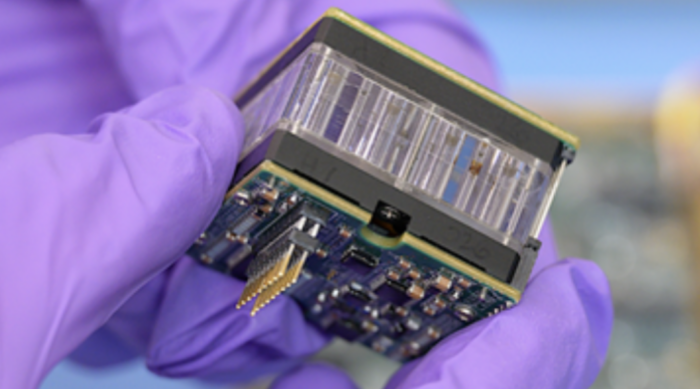 LEIA microfluidics card between electronics and optical sensors. Source: NASA 